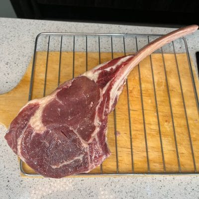 A tomahawk cut on a metal rack and a wooden board